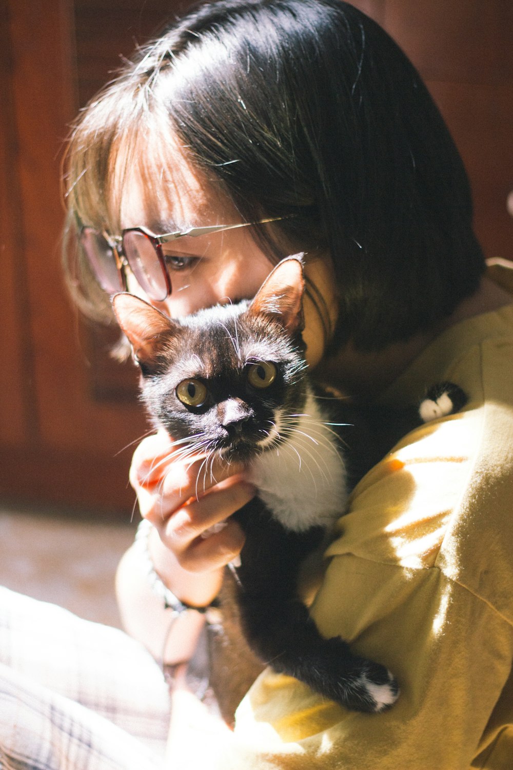 woman hugging cat