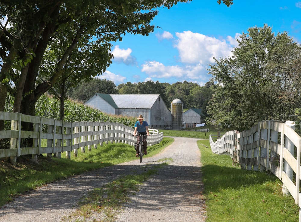 woman riding bicycle near road during daytime