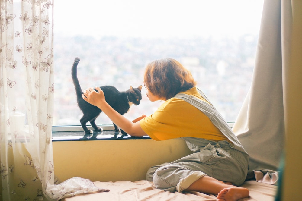 woman playing with cat