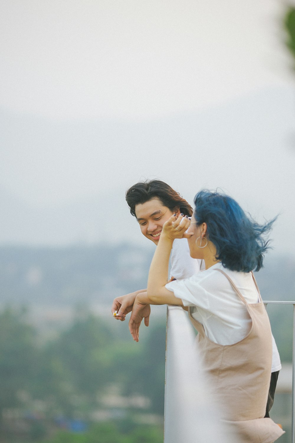 woman and man leaning on railings