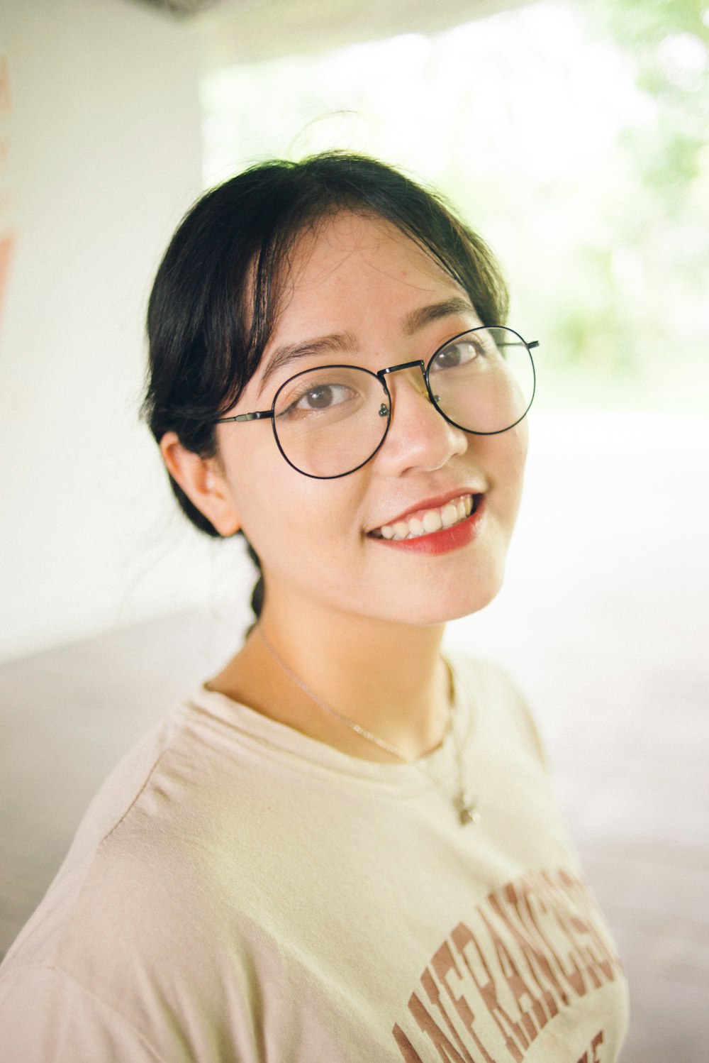 smiling woman in black framed eyeglasses