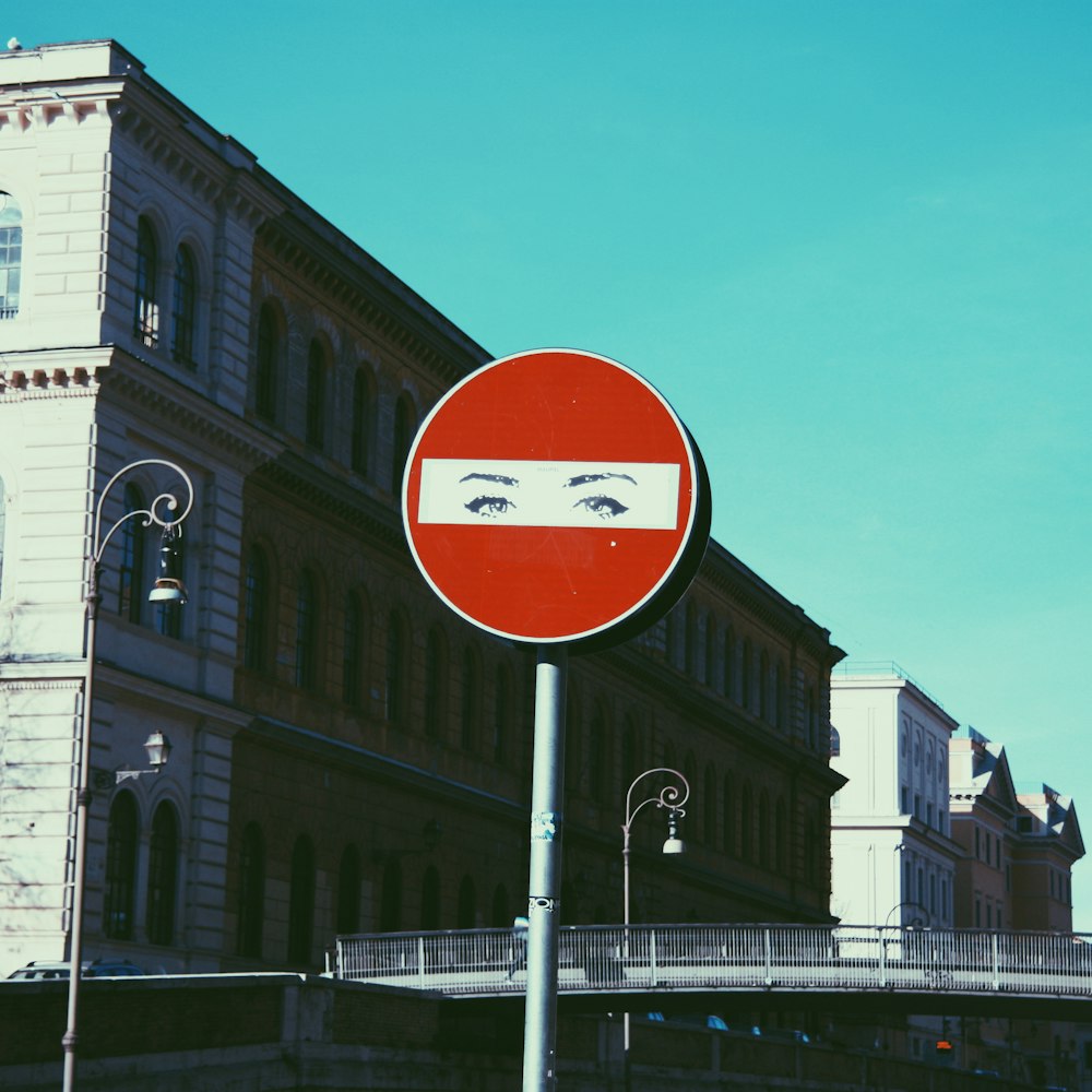 red sign pole across brown and white building