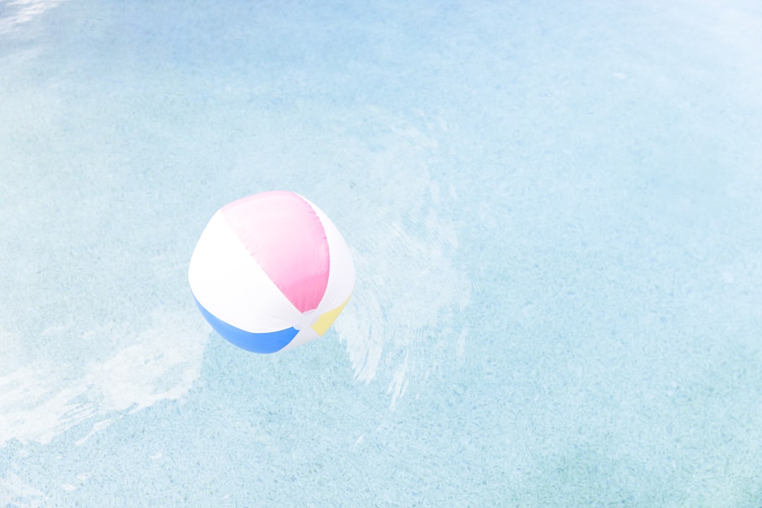 pool ball on pool, Beach ball in a swimming pool