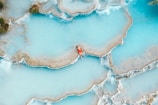 man sitting in body of water
