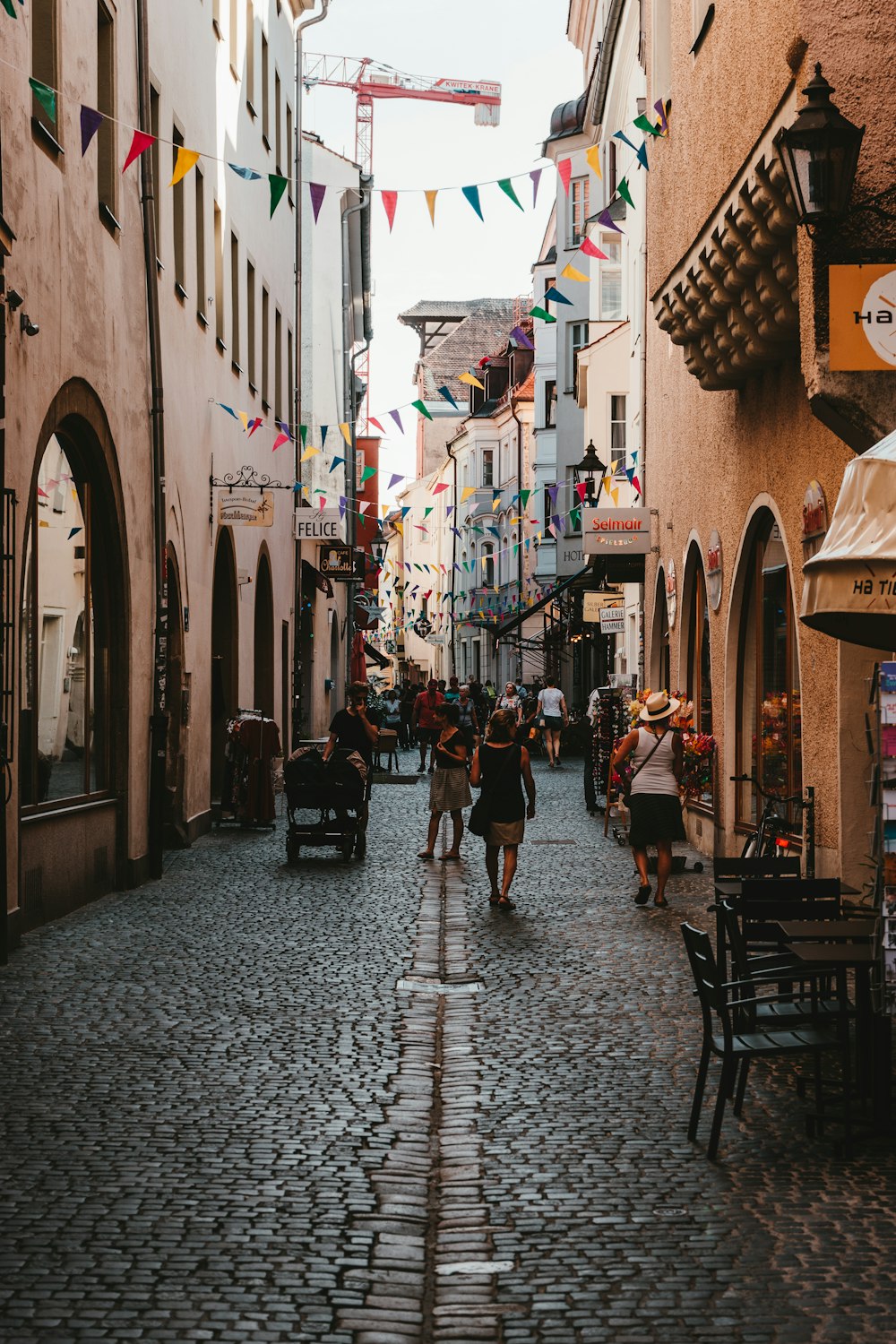 people walking on concrete road between buildings