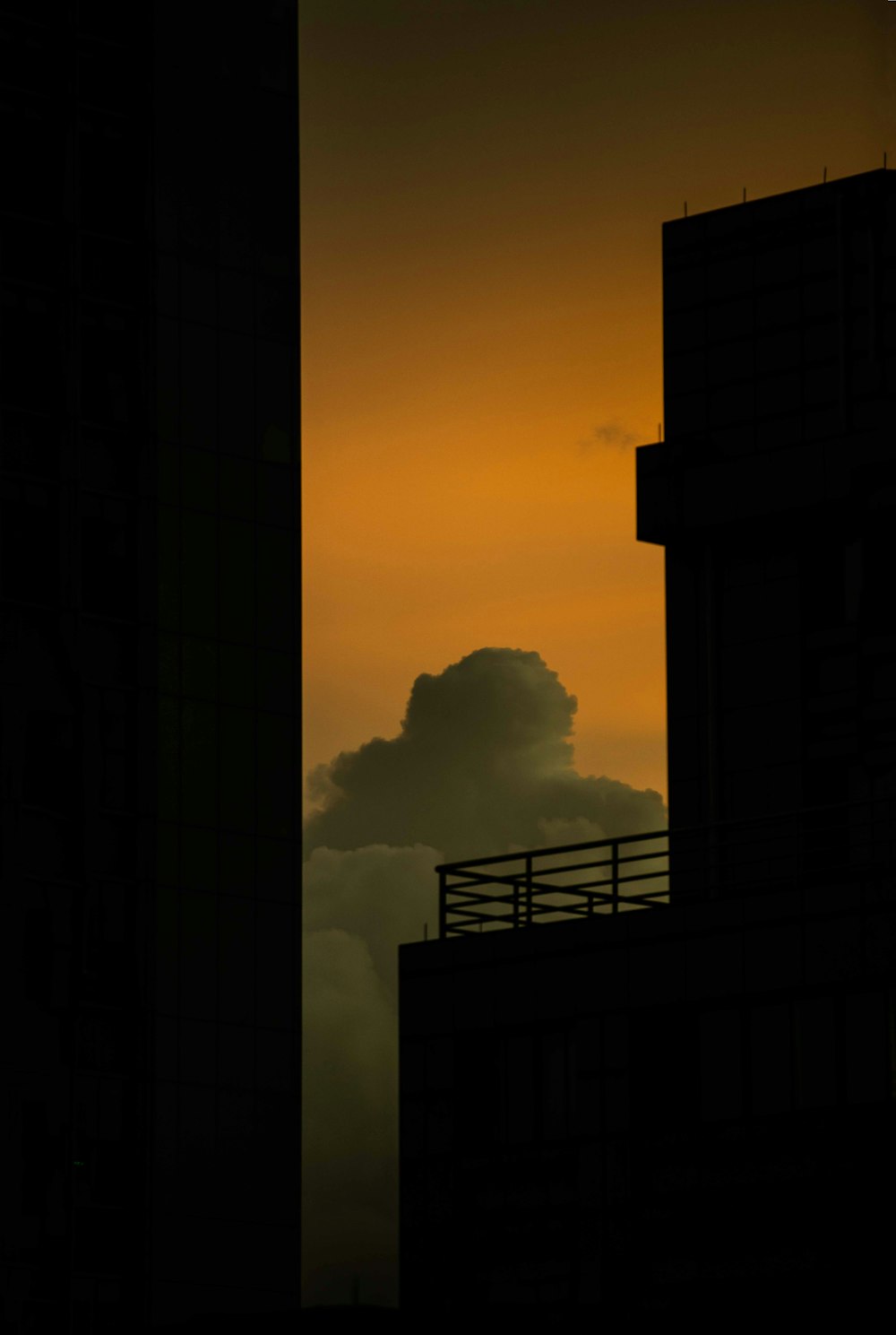 silhouette of buildings under gray skies