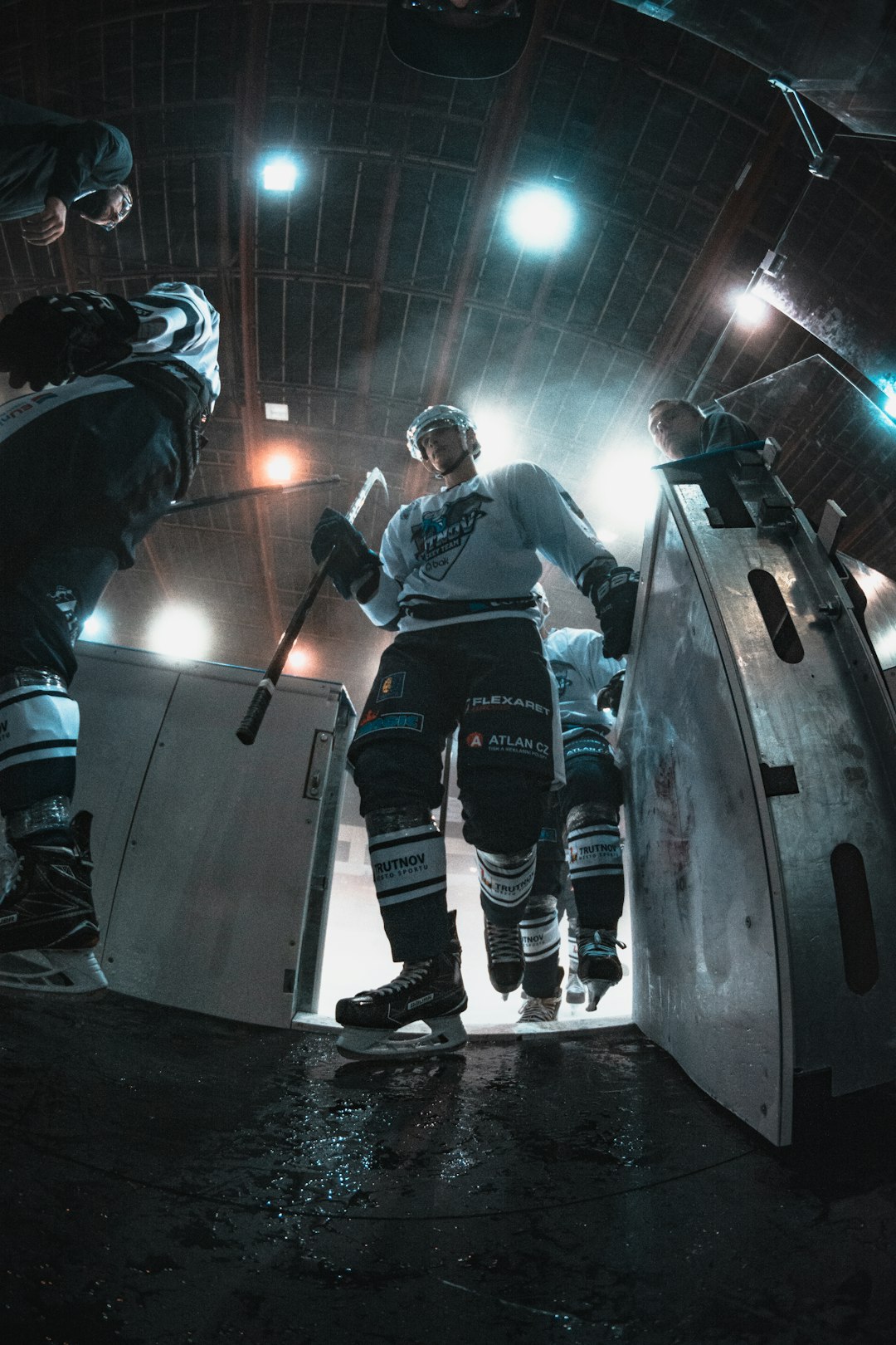 ice hockey players walking inside building