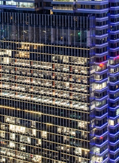 A panoramic view of a luxury commercial office tower with sleek architectural lines and ambient lighting.