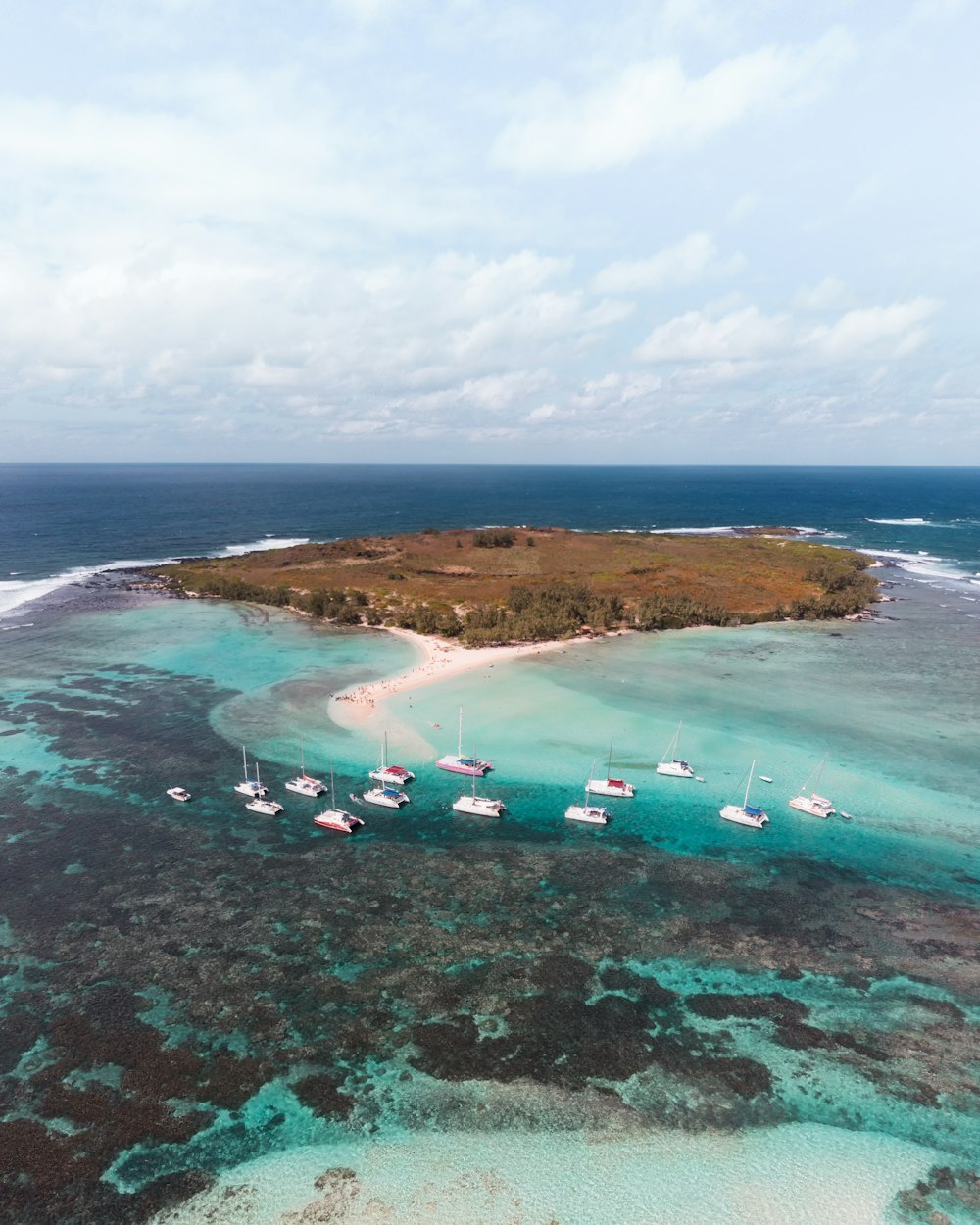 boats in sea near island