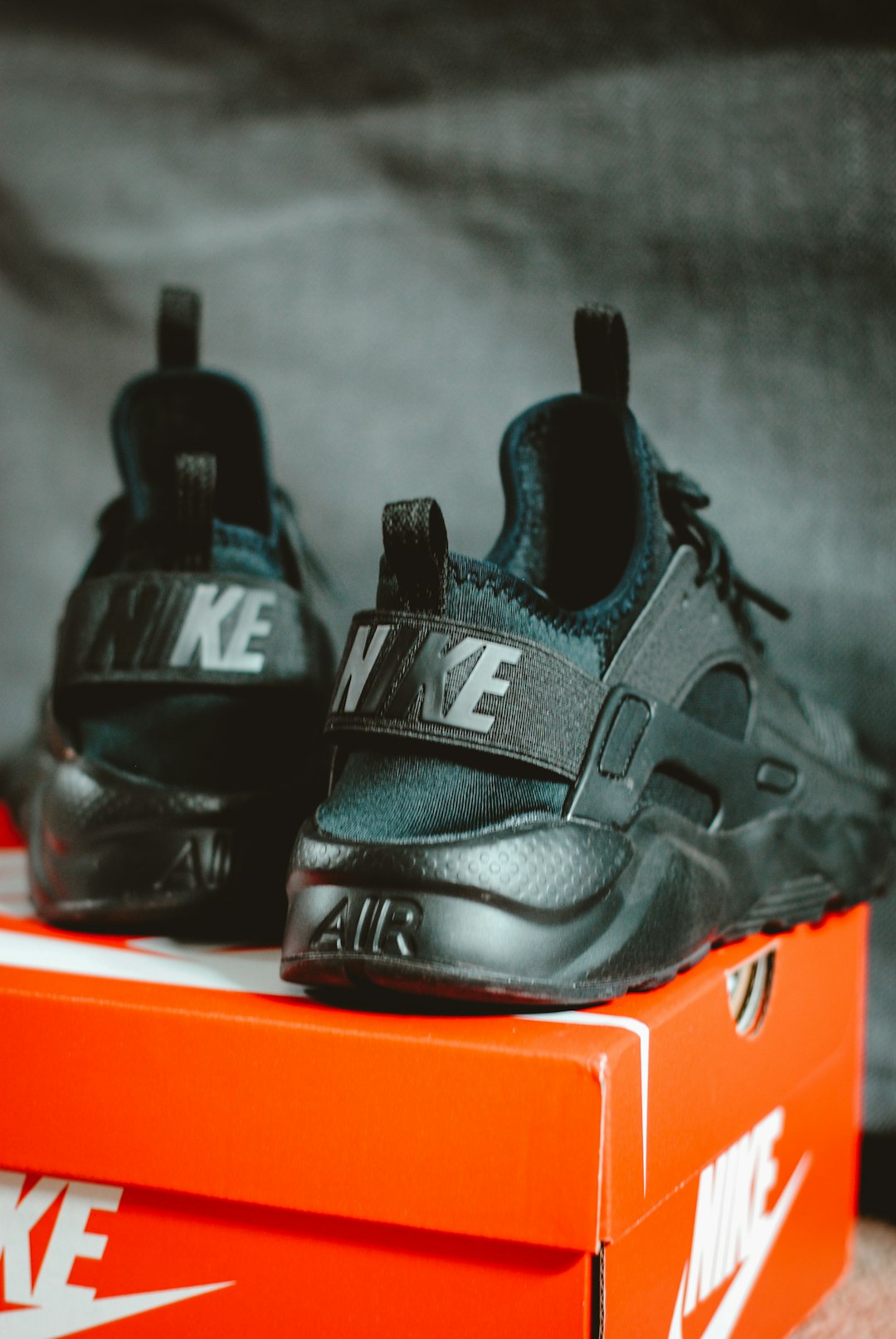 pair of triple black Nike Air Huarache sneakers