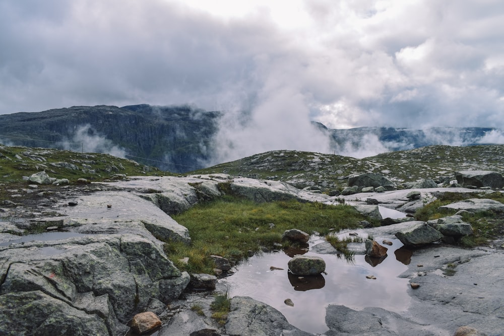 mountains under cloudy sky during daytime