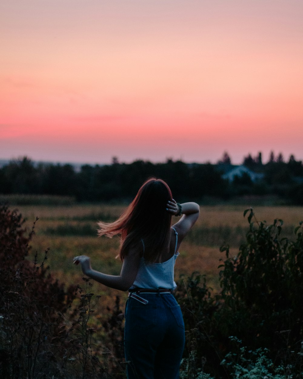 woman standing beside plants