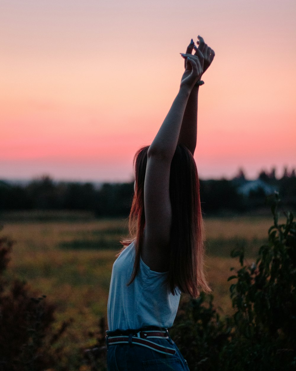 woman raising her hands above