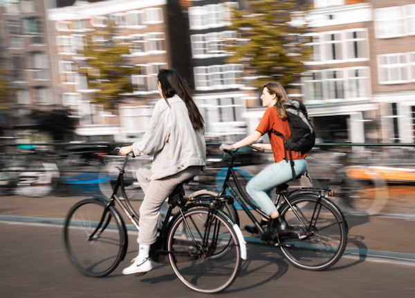 two women riding bicycles