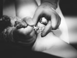 person doing flower tattoo on leg