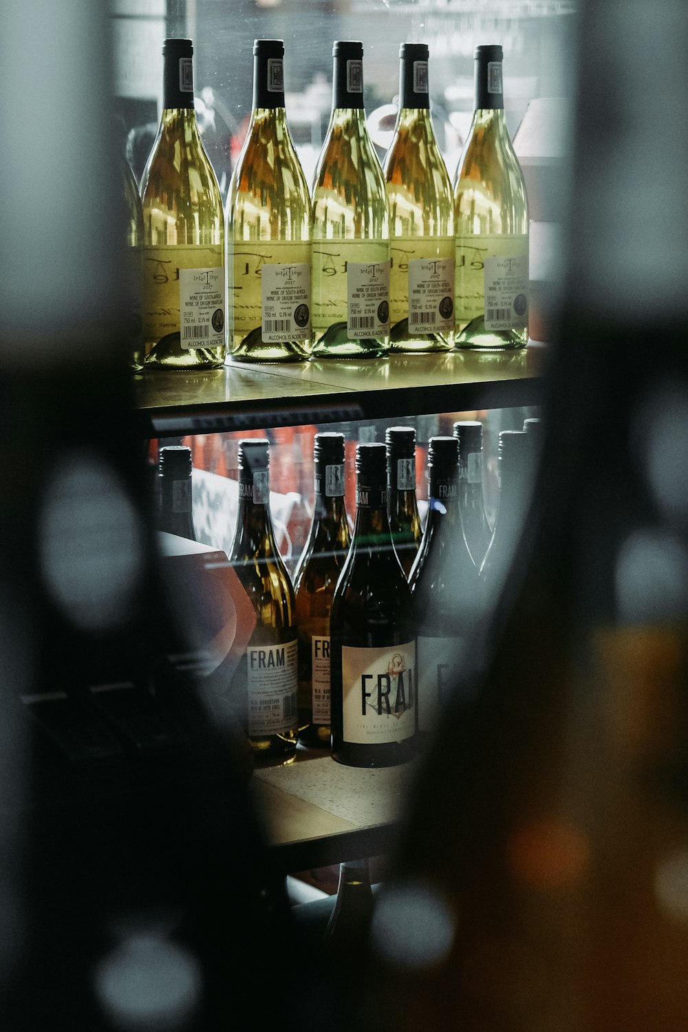 several bottles of wine sitting on a shelf