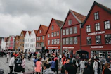 A vibrant street scene from a Scandinavian city with colorful buildings and people chatting.