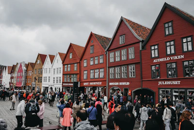 A vibrant street scene from a Scandinavian city with colorful buildings and people chatting.