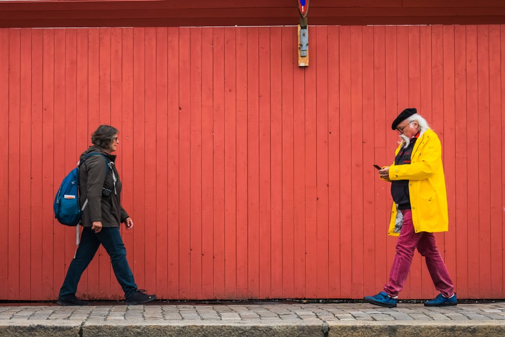 man and woman walking on sidewalk