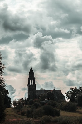Historic church with surrounding land poised for redevelopment, framed by slate gray clouds.