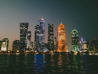 A sleek, dark-themed cityscape at night with glowing orange and cyan lights highlighting key neighborhoods.