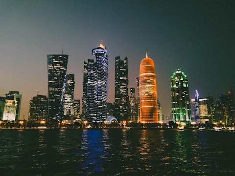 A striking nighttime cityscape with glowing orange and cyan accent lights highlighting urban vibrancy.