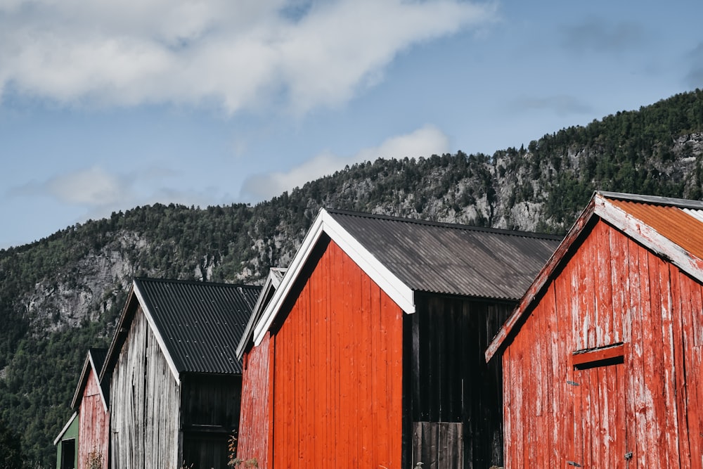 brown and gray barns near mountain