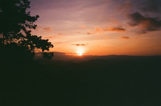 A scenic sunset view over a popular tourist destination with mountains.
