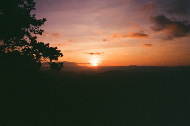 A scenic sunset view over a popular tourist destination with mountains.
