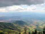Wide view of the lush green pastures and rolling hills in Vall d’en Bas.