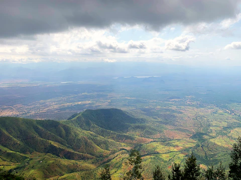 Wide view of the lush green pastures and rolling hills in Vall d’en Bas.
