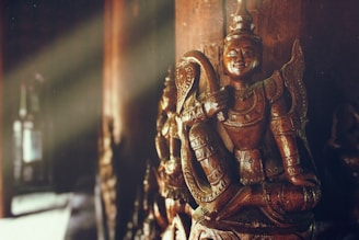 selective focus photography of brown statues