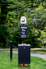 Friendly team member scooping pet waste in an apartment complex