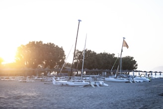 Sunset view from a Lagoon catamaran anchored near a Caribbean island with palm trees.
