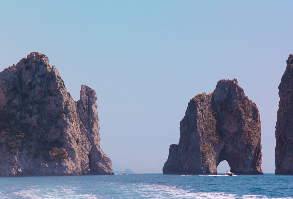 a group of rocks sticking out of the ocean