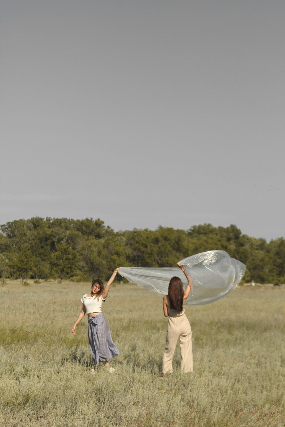 two woman holding blanket