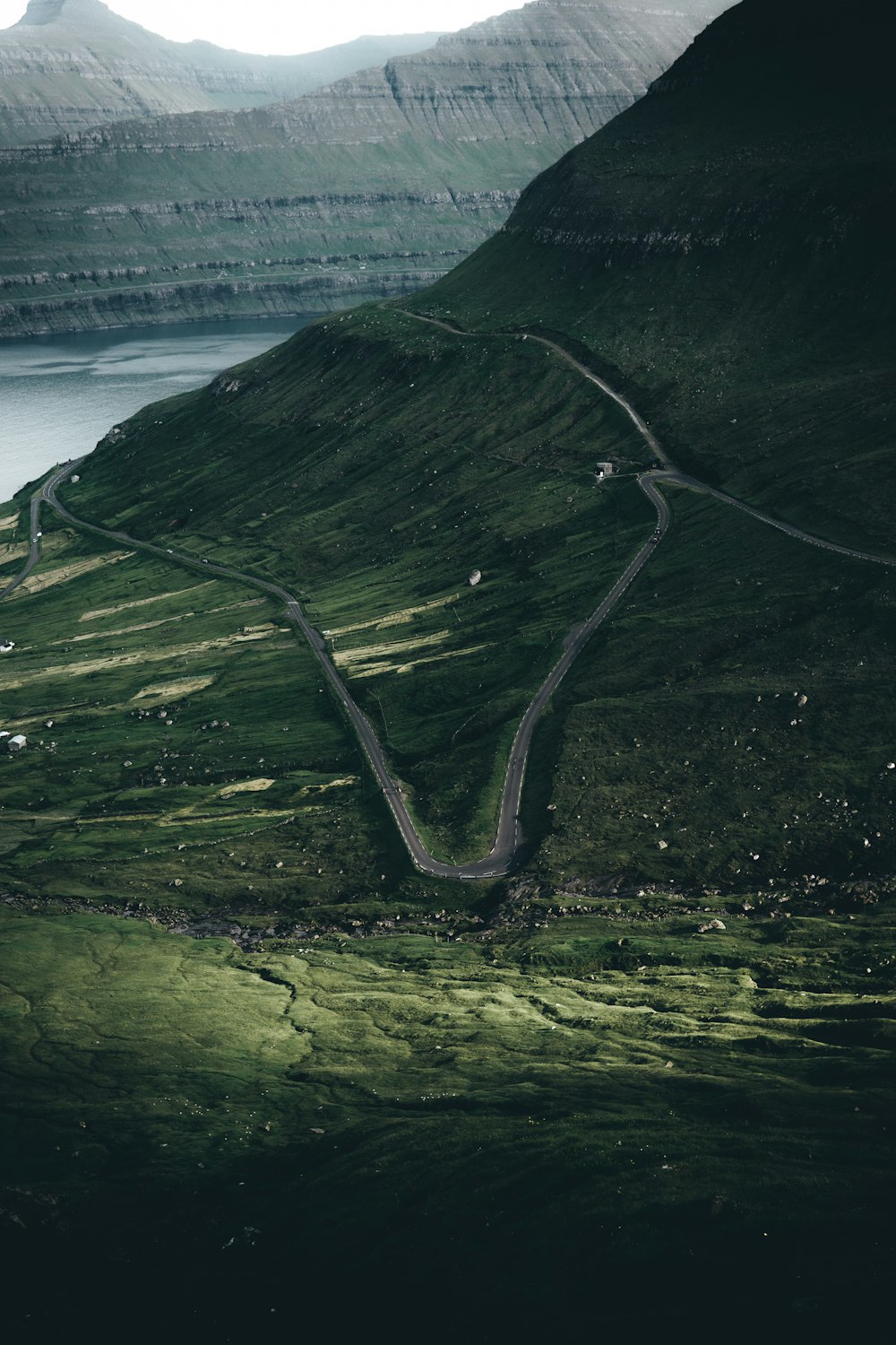 a winding road in the middle of a mountain range