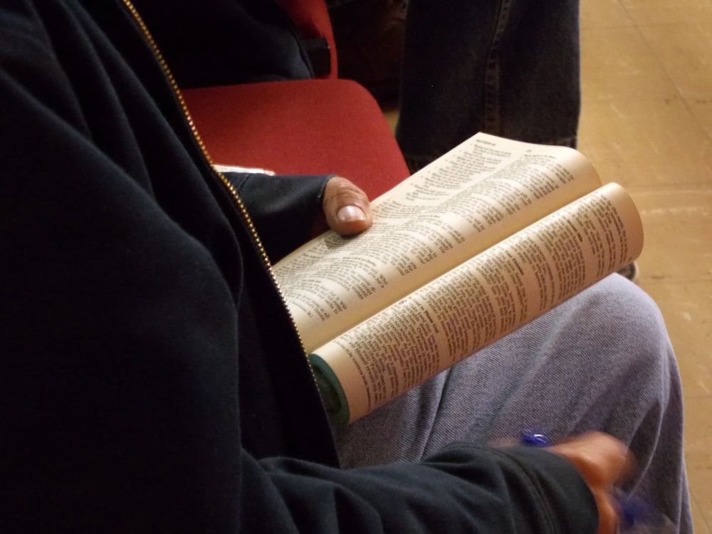 unknown perrson holding brown book