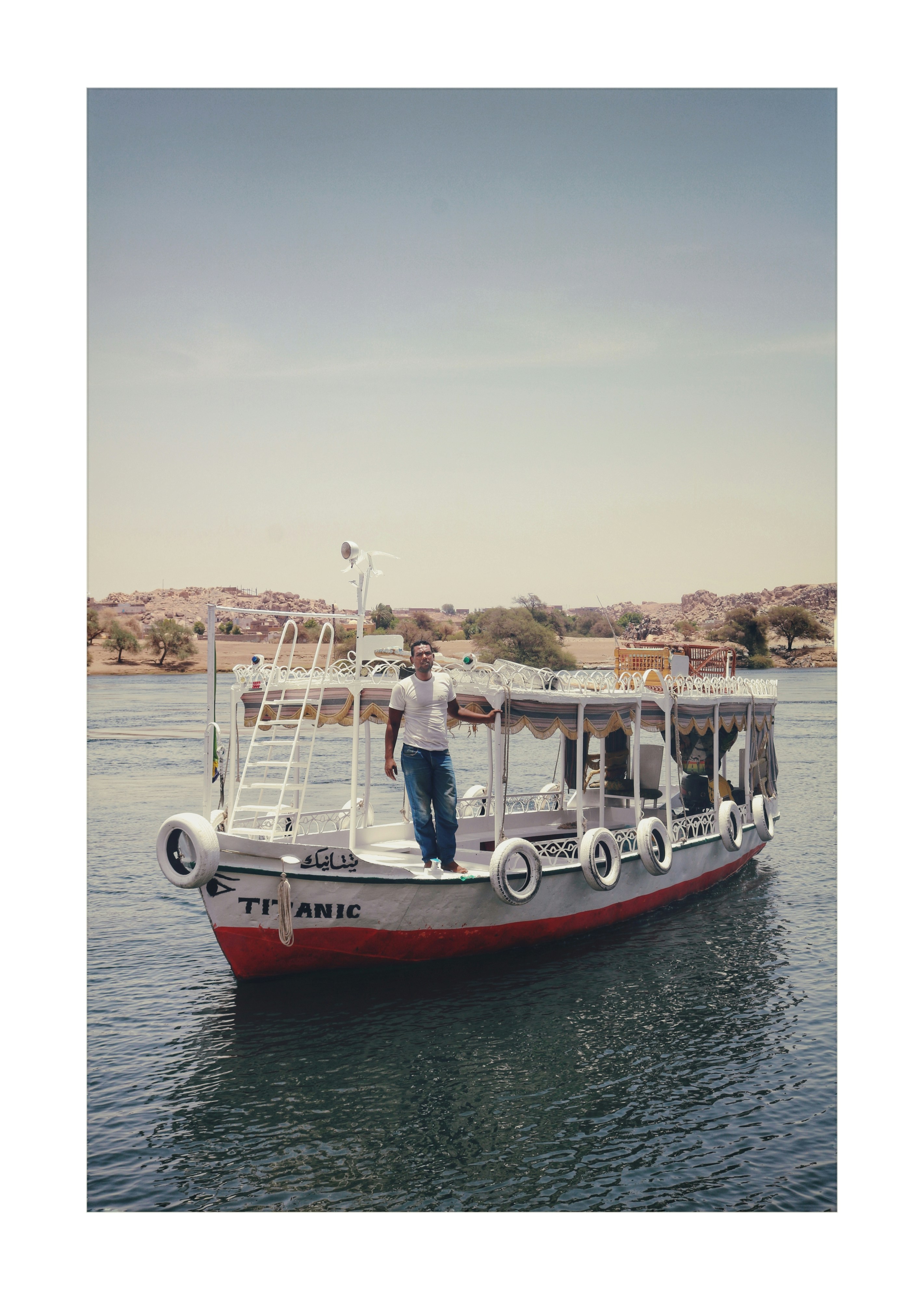 man standing on boat during daytime