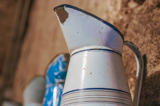 a blue and white vase sitting on top of a wooden table