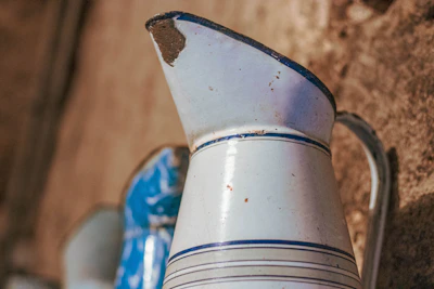 a blue and white vase sitting on top of a wooden table