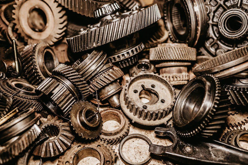 Collection of transmission gears, bearings and drivetrain components laid out on a workbench