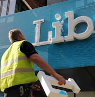 external sign installation of blue and white 3D sign panel