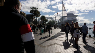 A bustling cruise ship promenade filled with happy travelers.