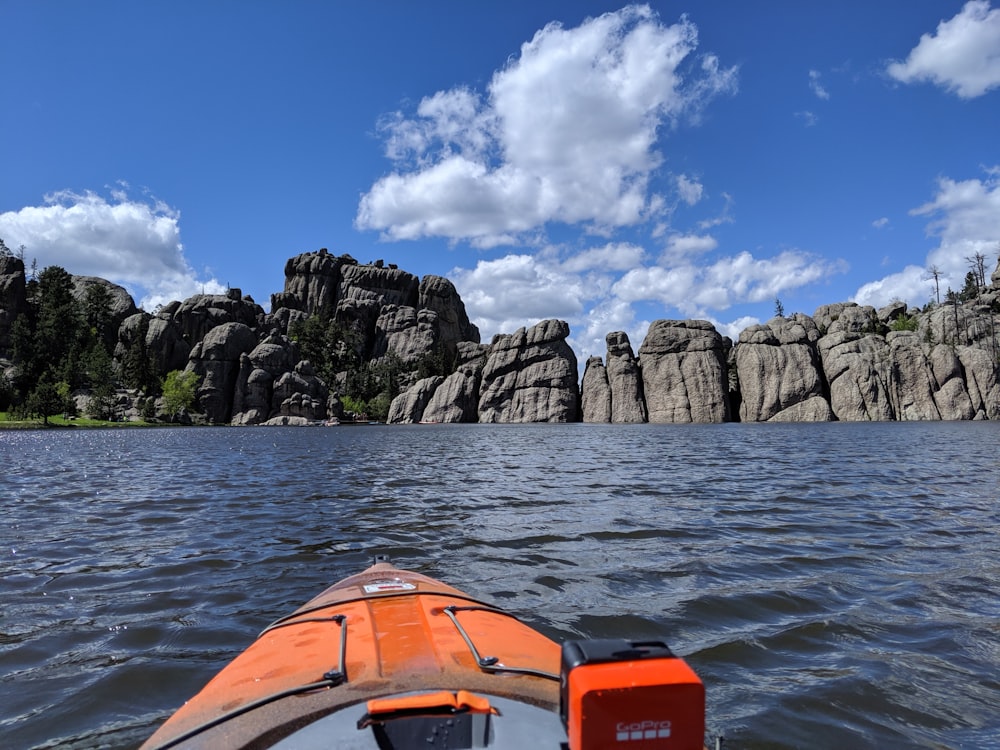 boat floating towards rocky island