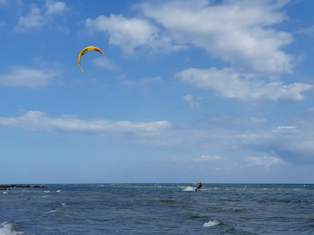 person riding parasailing