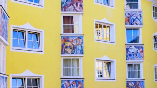 Brightly painted exterior facade with cheerful yellow and blue tones highlighting fresh plaster work.