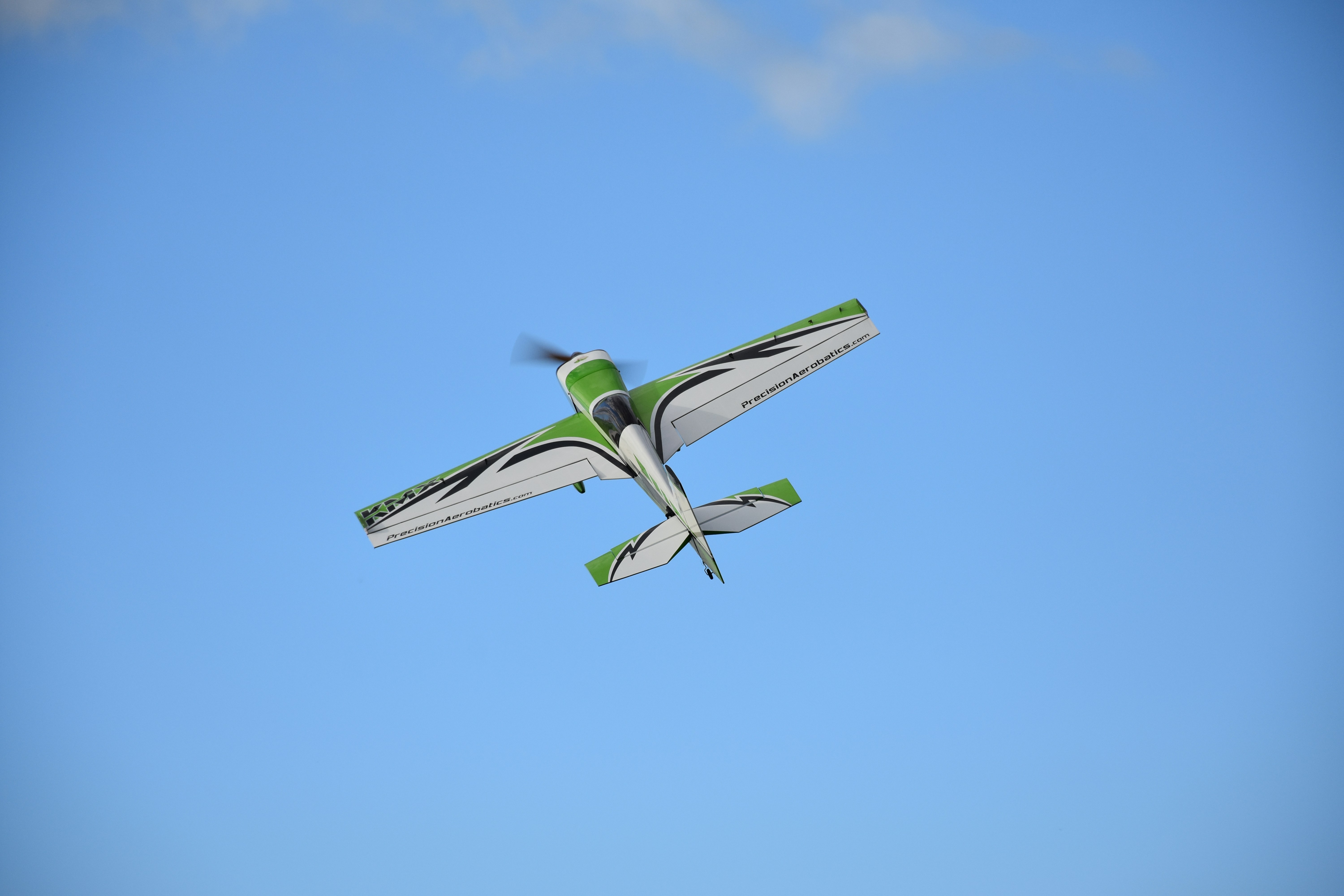 white and green biplane