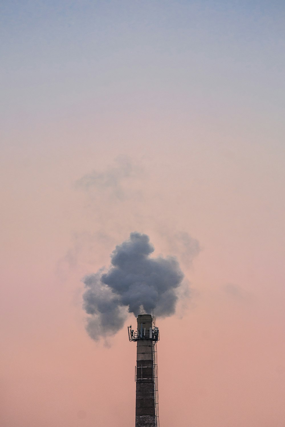 high rise building with smoke on top