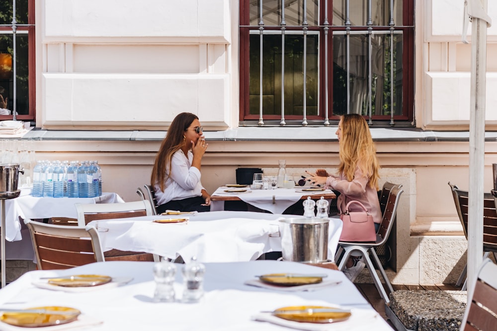 two women sitting at the table